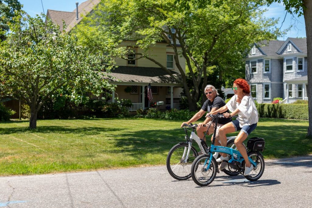 Couple riding electric bikes on sunny day - best summer e-bikes